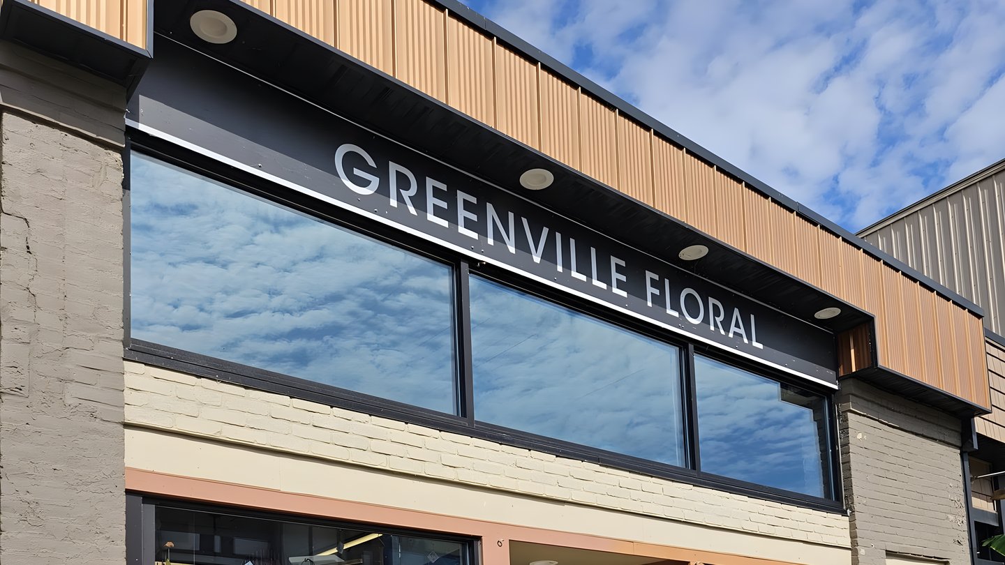 The Greenville Floral shopfront at 221 S. Lafayette Street in downtown Greenville, Michigan, with the shop name on the sign above the windows.
